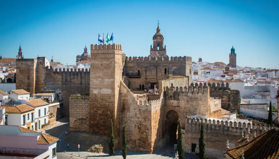 Puerta de Sevilla (Carmona) 3 Fortaleza medieval en Carmona, España, con cielo azul.